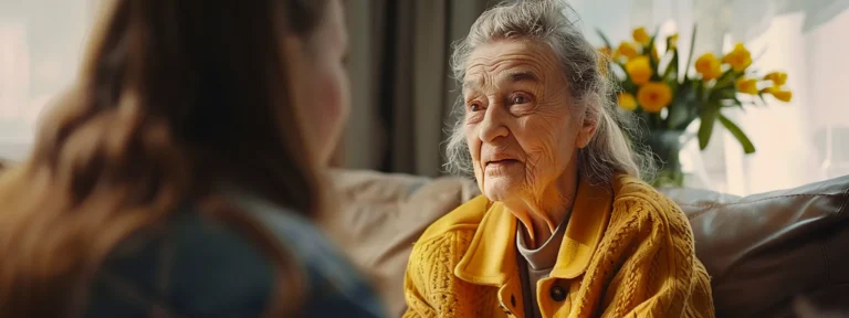 a caring family member video calling an elderly loved one receiving home care, with a warm smile on their face.